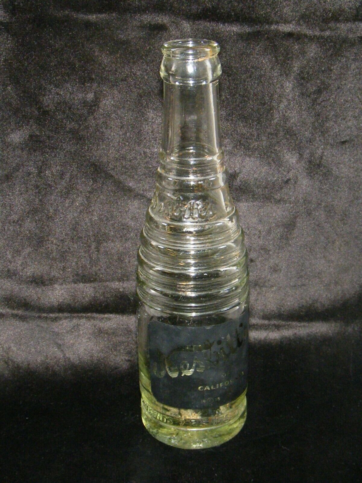 1938 NESBITTS OF CALIFORNIA 7 OZ BLACK LABEL GLASS SODA BOTTLE