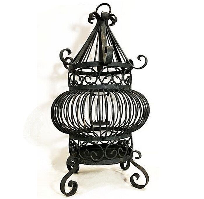 Vintage wrought iron bird cage. Persian Arabesque style with curlique legs.