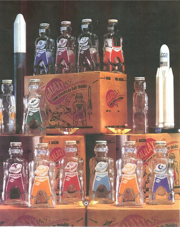 12 GALAXY SPACE FOODS  SPACEMAN   ASTRONAUT SODA SYRUP  BOTTLE COIN BANKS 1950'S