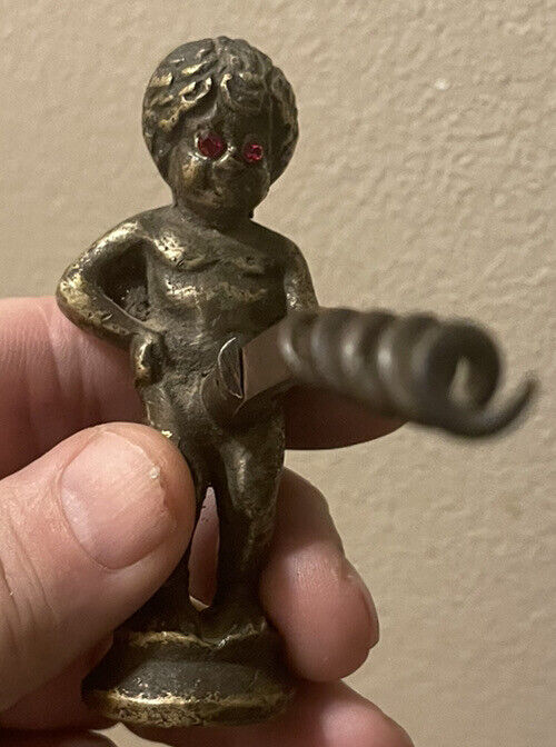 Antique naughty boy corkscrew peeing from Portugal with red glass eyes Brass