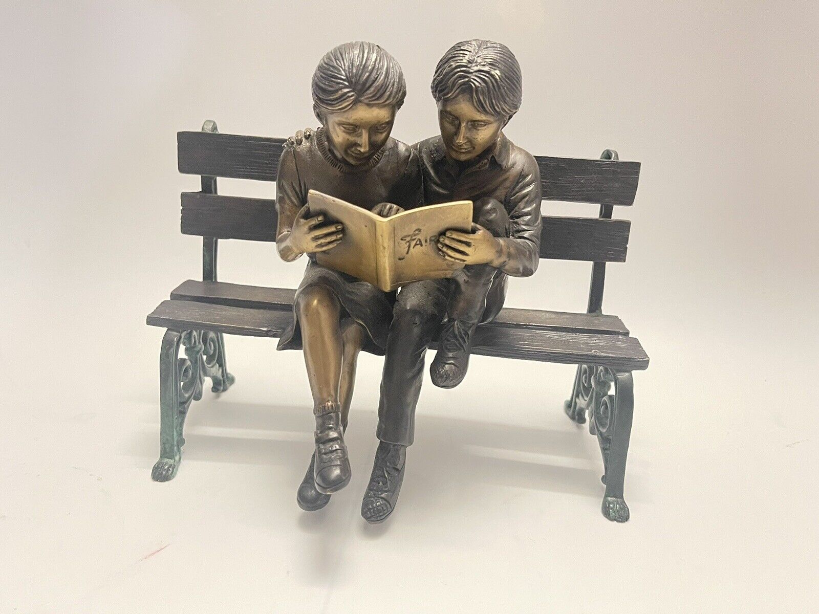 Two kids on bench reading a book Bronze Statue LOOK 👀