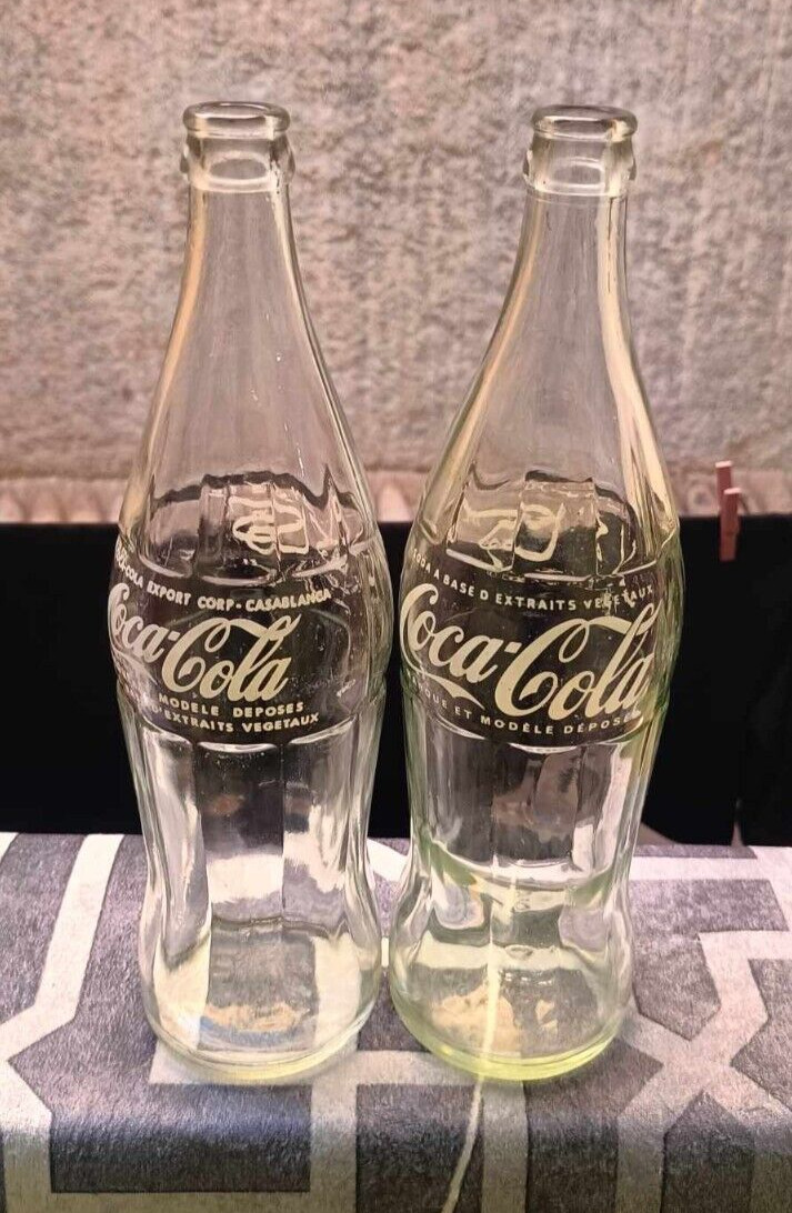 tow vintage Coca-Cola bottles of 77 CL arabic writting old moroco and one line