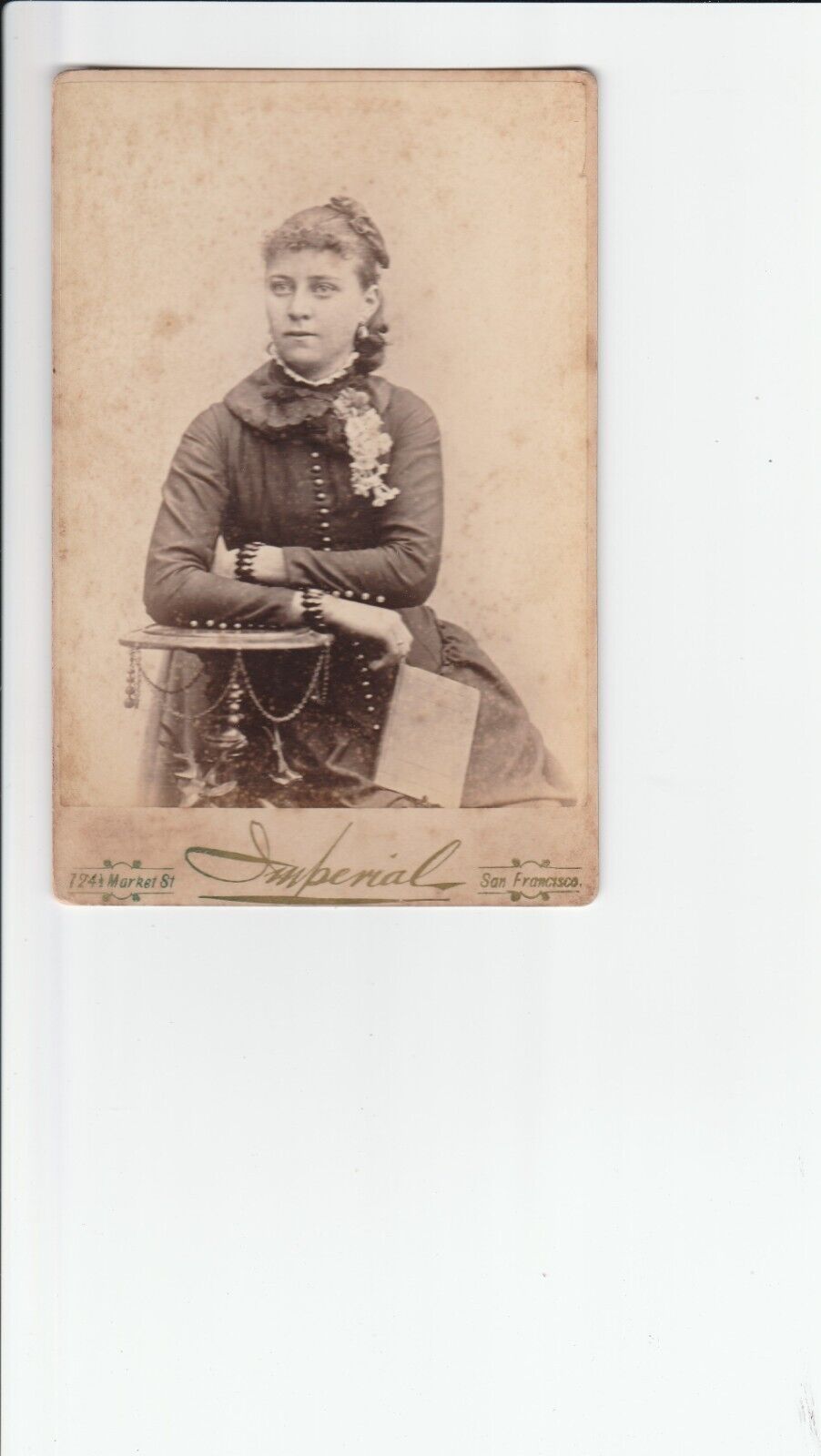 Cabinet Card 1877 S.F. CA,VICTORIAN LADY FLOWER CORSAGE,CURLY HAIR,JEWELRY, BOOK