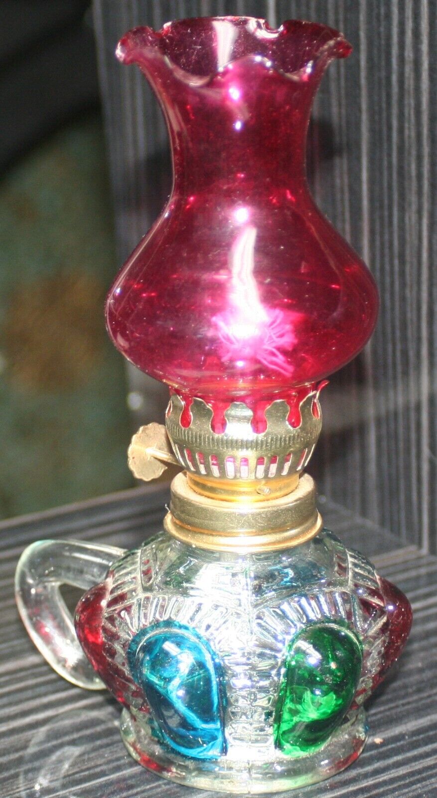 Vintage Singing Bird Brand multi-colored finger-hold mini oil lamp w/ red chimny