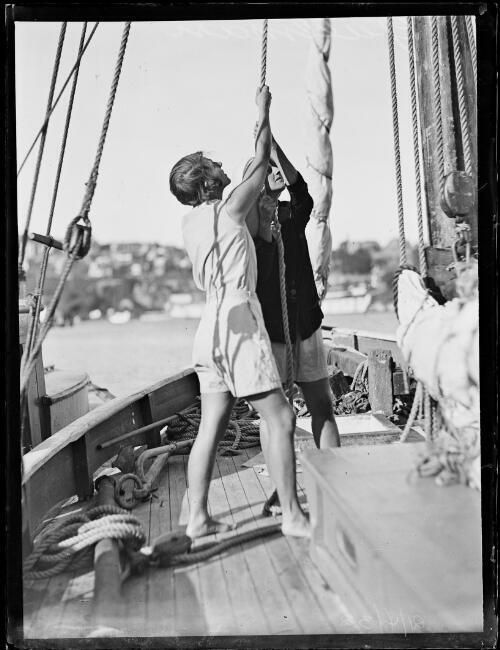 Captain Mr G.H. Metcalf and his wife hoisting the sail onboard the - Old Photo