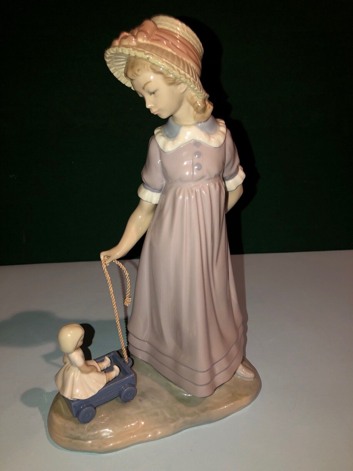 Lladro Girl pulling toy wagon with doll inside, # 5044 Girl Figurine