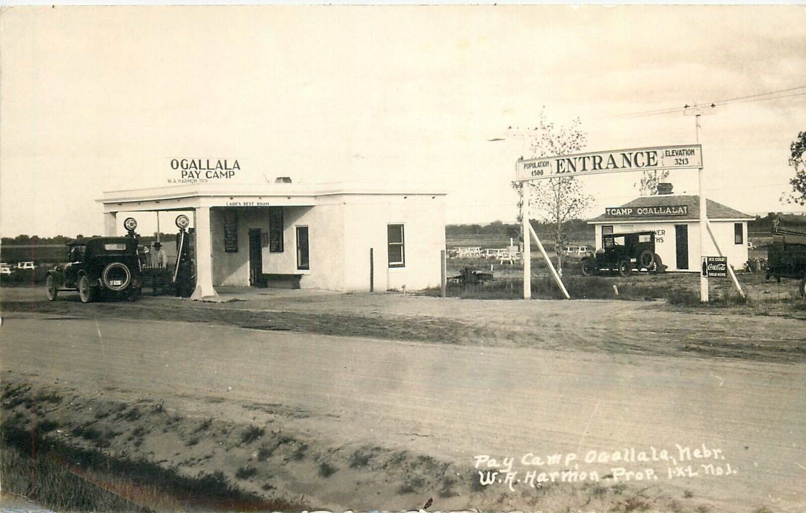 Postcard RPPC 1928 Nebraska Ogallala Gas Station Pay Camp automobiles NE24-1643