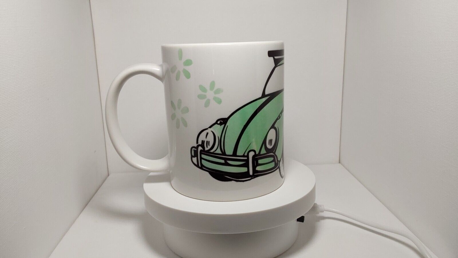Handmade VW Beetle watercolor green coffee mug cup. Surrounded by spring flowers