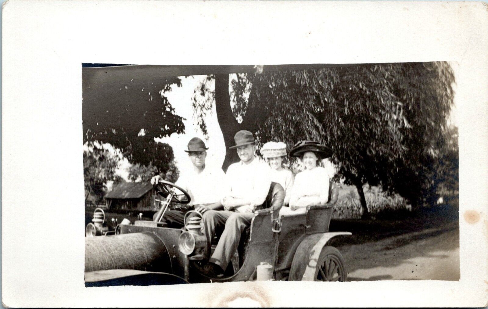 RPPC - Two Couples in Antique Car on Road - Photo Postcard - Ladies in Big Hats