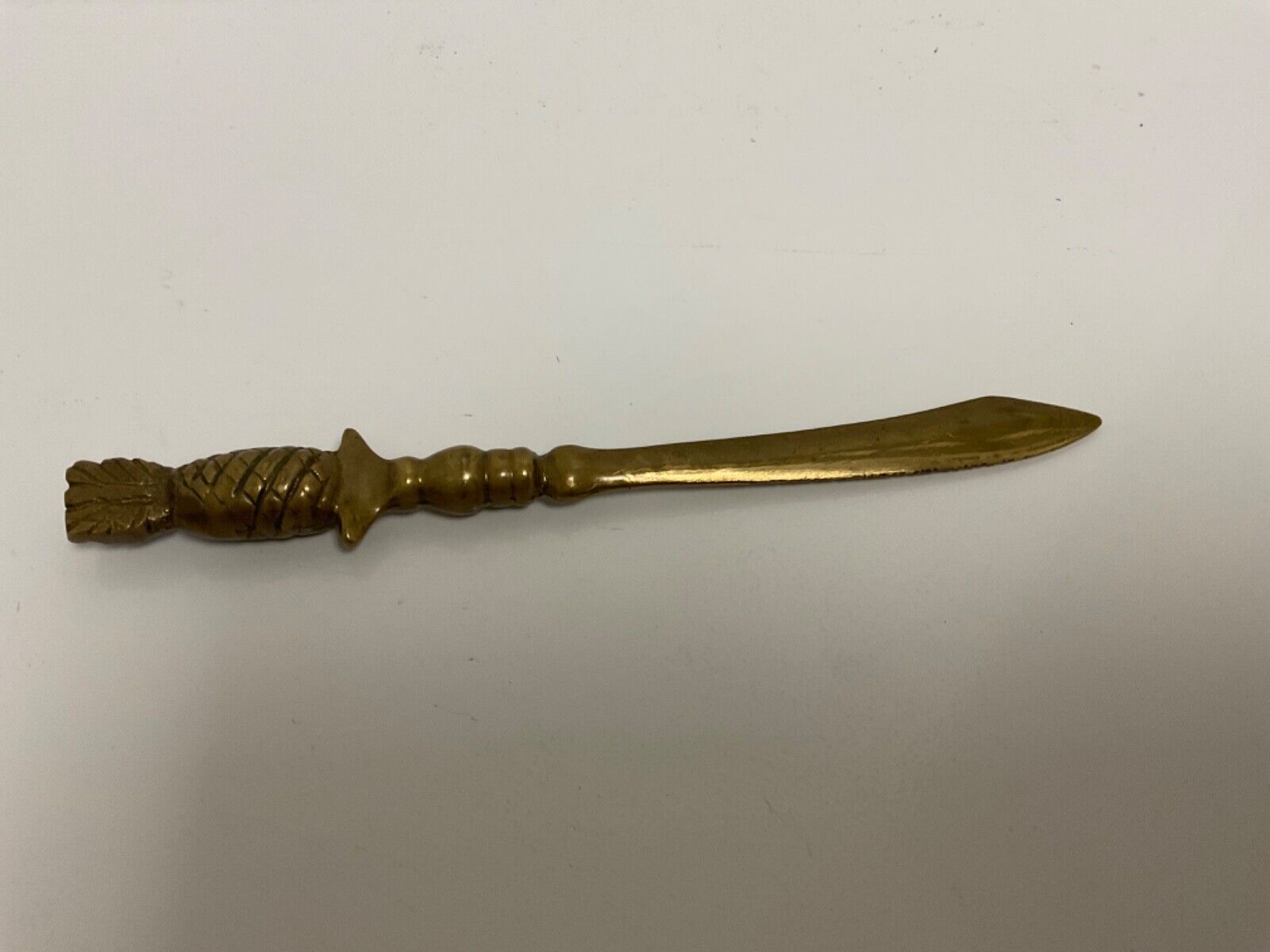 Heavy Vintage brass letter opener, saber style topped w hospitality pineapple