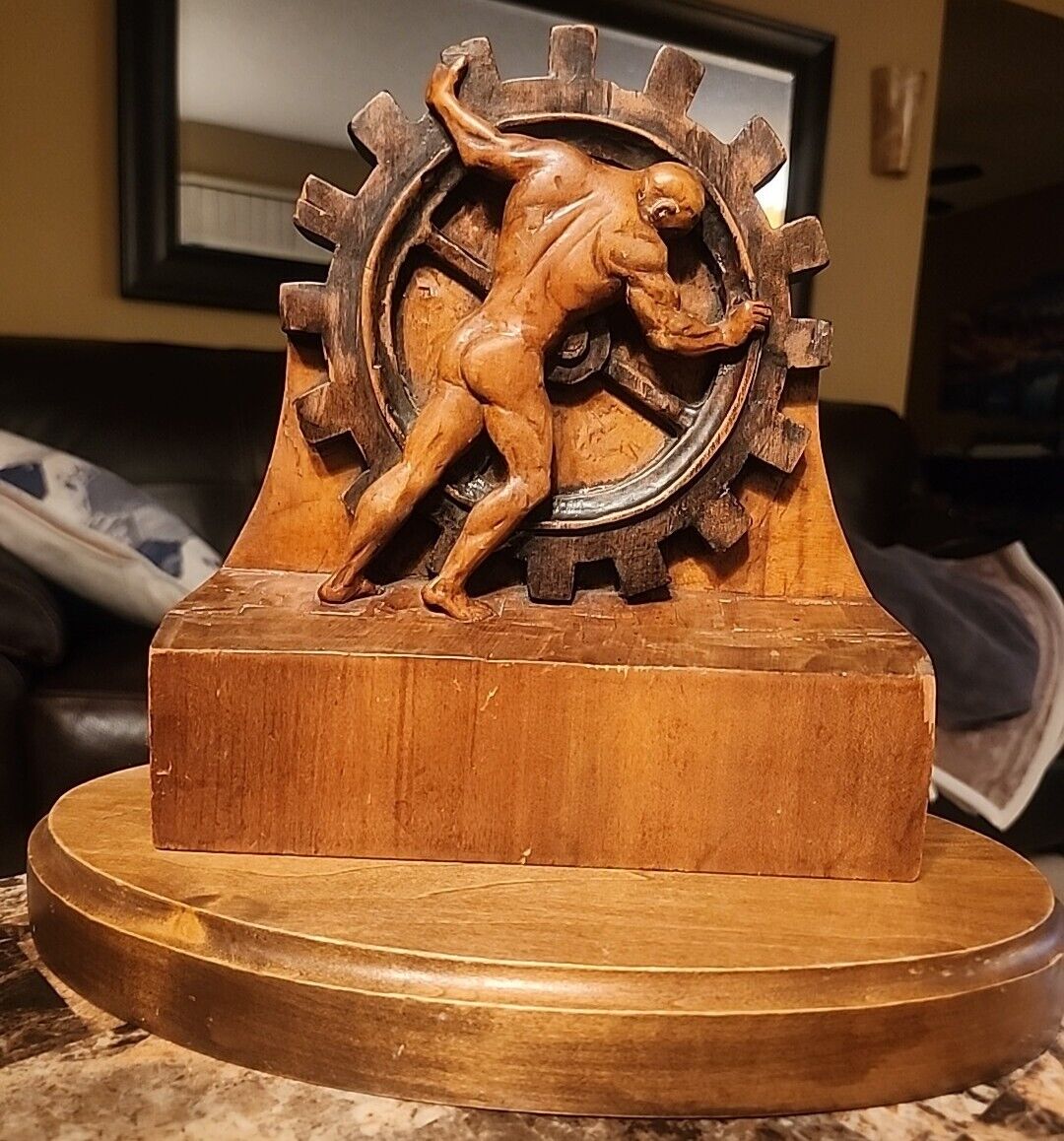 Vintage Man Pushing Gear Wheel Wood Carving 1935