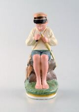 Royal Copenhagen porcelain figurine in high quality over glaze. Young boy, 1920s picture