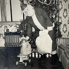 Vintage 1950s B&W Snapshot Photograph Santa Claus Gifts Doll Odd Christmas picture