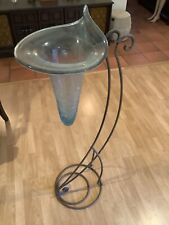 Tall black wrought iron Stand with a cone shaped crackle glass vase picture