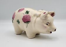 Ceramic piggy bank.  White with pink flower pattern.  Appears quite old. picture