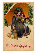 1914 Christmas Postcard Embossed With Santa Seal, Woman & Child Carrying Gifts picture