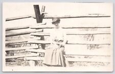Postcard RPPC Woman Sitting on Wooden Fence Holding Cat c1910 picture