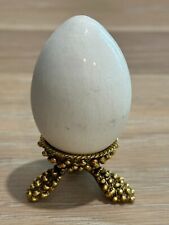 White Ceramic Egg on Gold Metal Pedestal picture