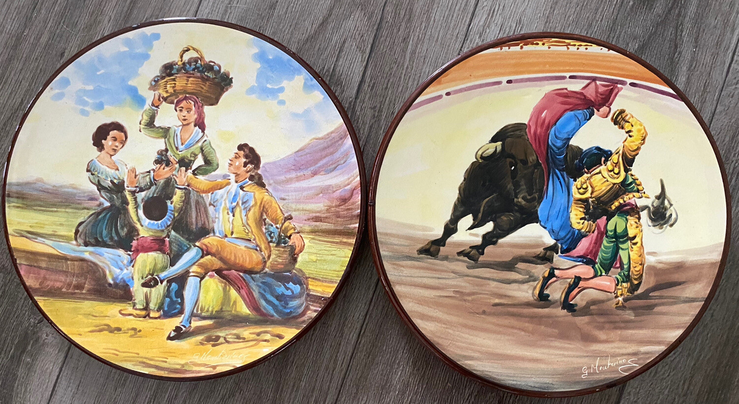 2 Vtg hand painted wall plates. Grape harvest, matador & bull fight. Signed. 2 Vtg hand painted wall plates. Grape harvest, matador & bull fight. Signed.