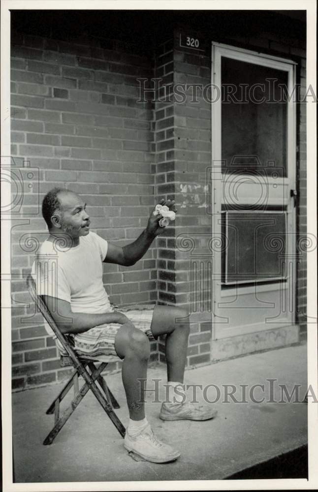 1985 Press Photo John C. Suber Sits on His Porch, Piedmont Courts Apartments, NC 1985 Press Photo John C. Suber Sits on His Porch, Piedmont Courts Apartments, NC