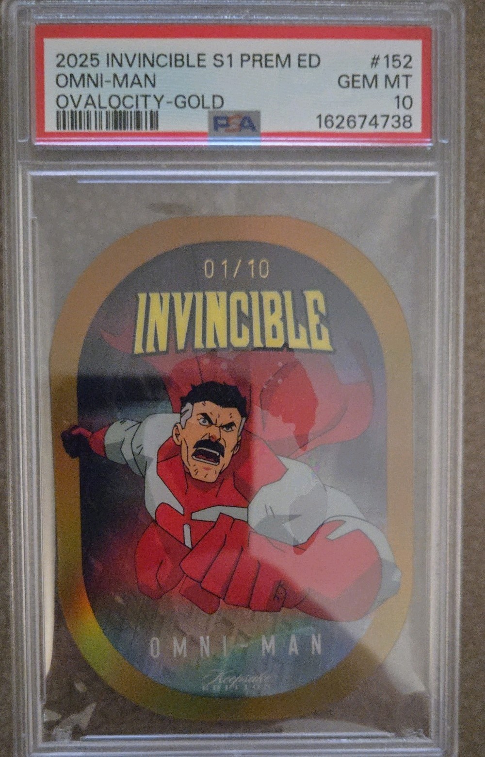 OMNI-MAN 2025 INVINCIBLE 1/10 OVALOCITY-GOLD PREM ED DIE-CUT PSA 10 KEEPSAKE
