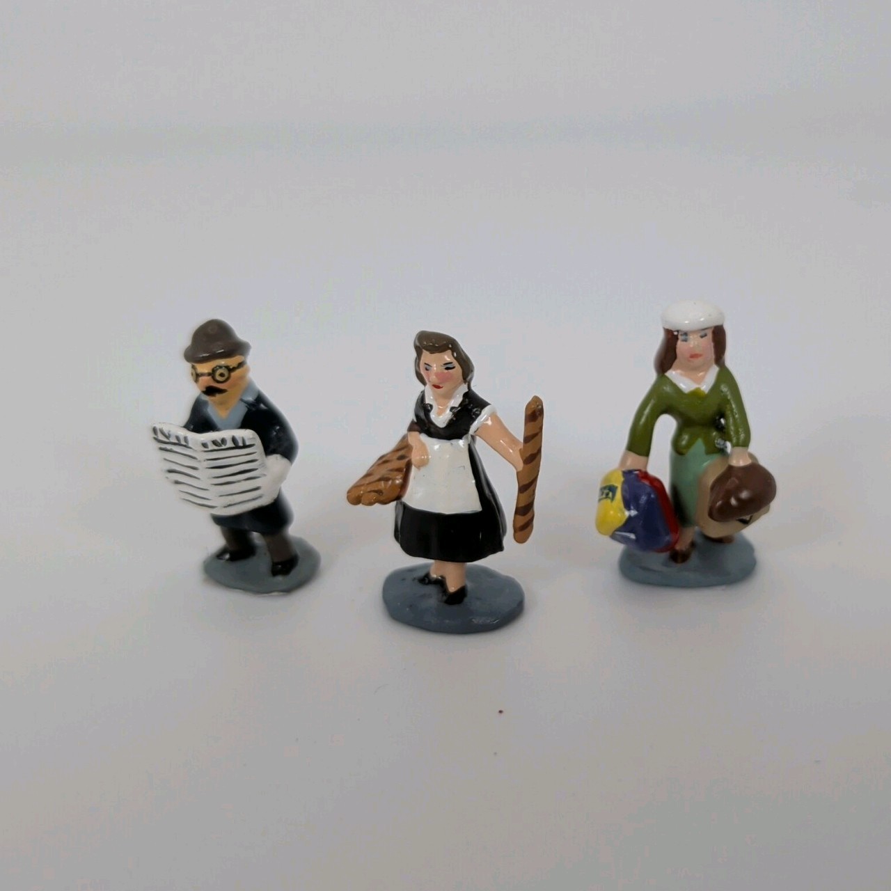 J Carlton by Gault French Miniature set of 3 Man Reading Paper, Women &luggage, 