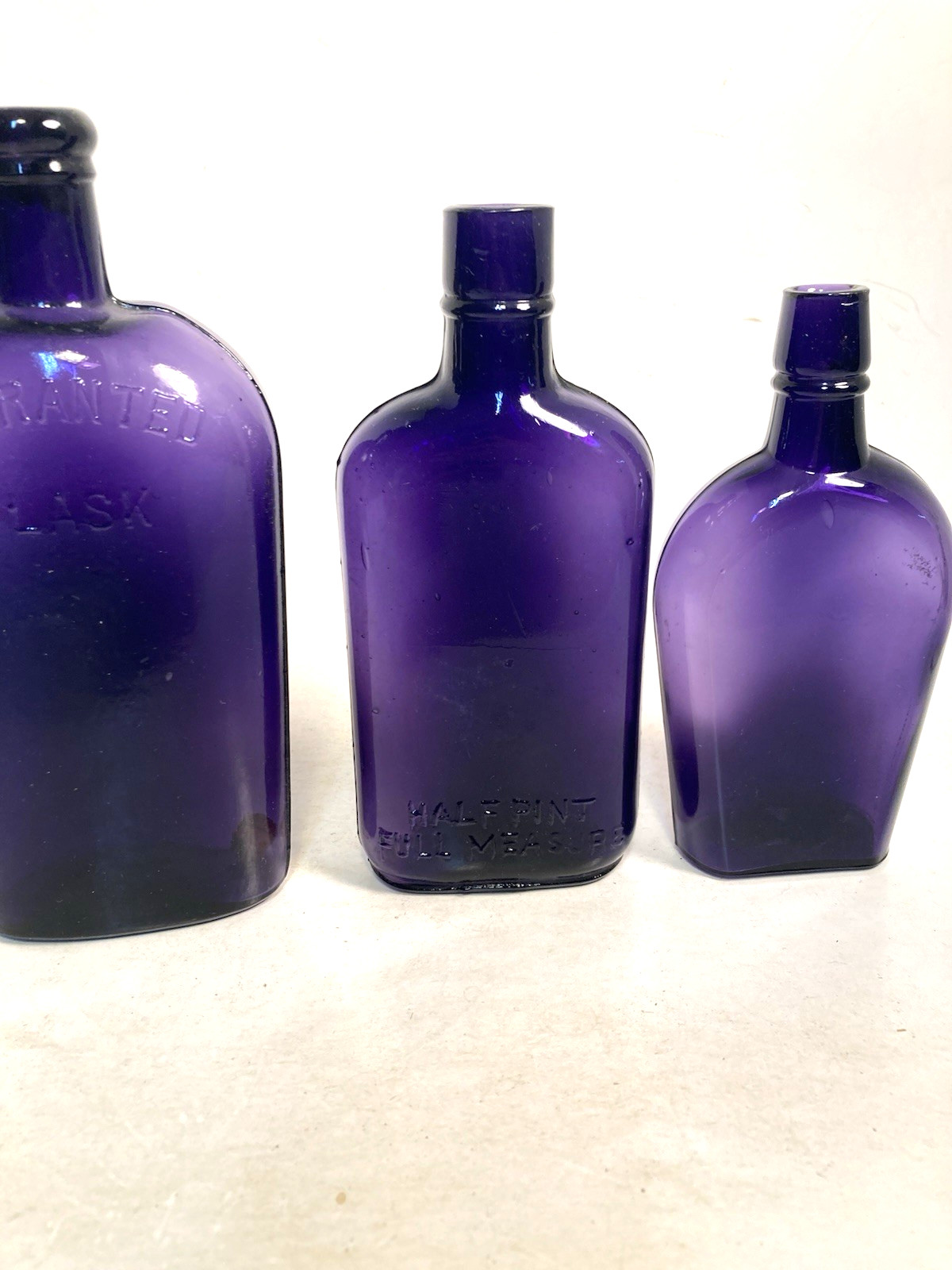 Vintage Purple Glass Whiskey Bottles, 2 EMBOSSED, 1 NOT, NOT DUG bottles Vintage Purple Glass Whiskey Bottles, 2 EMBOSSED, 1 NOT, NOT DUG bottles