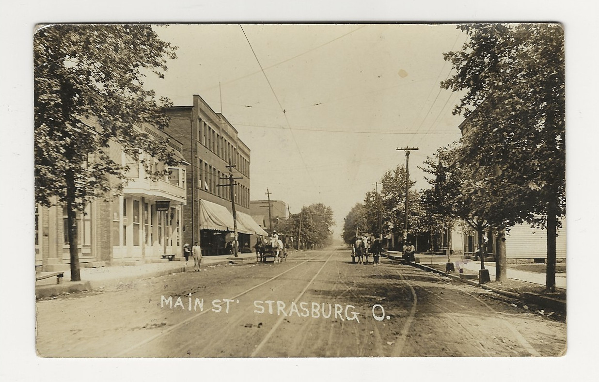 VERY NICE 1909 RPPC - Main Street in Strasburg, Ohio. VERY NICE 1909 RPPC - Main Street in Strasburg, Ohio.