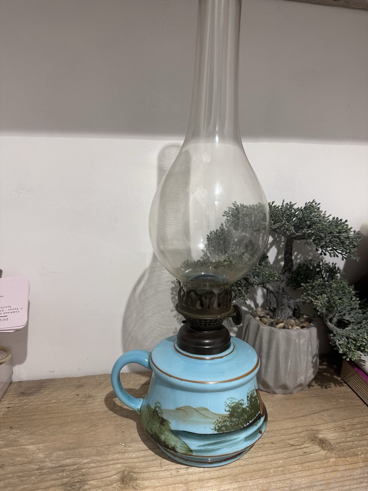 An antique finger oil lamp with custard glass font, brass burner & glass chimney