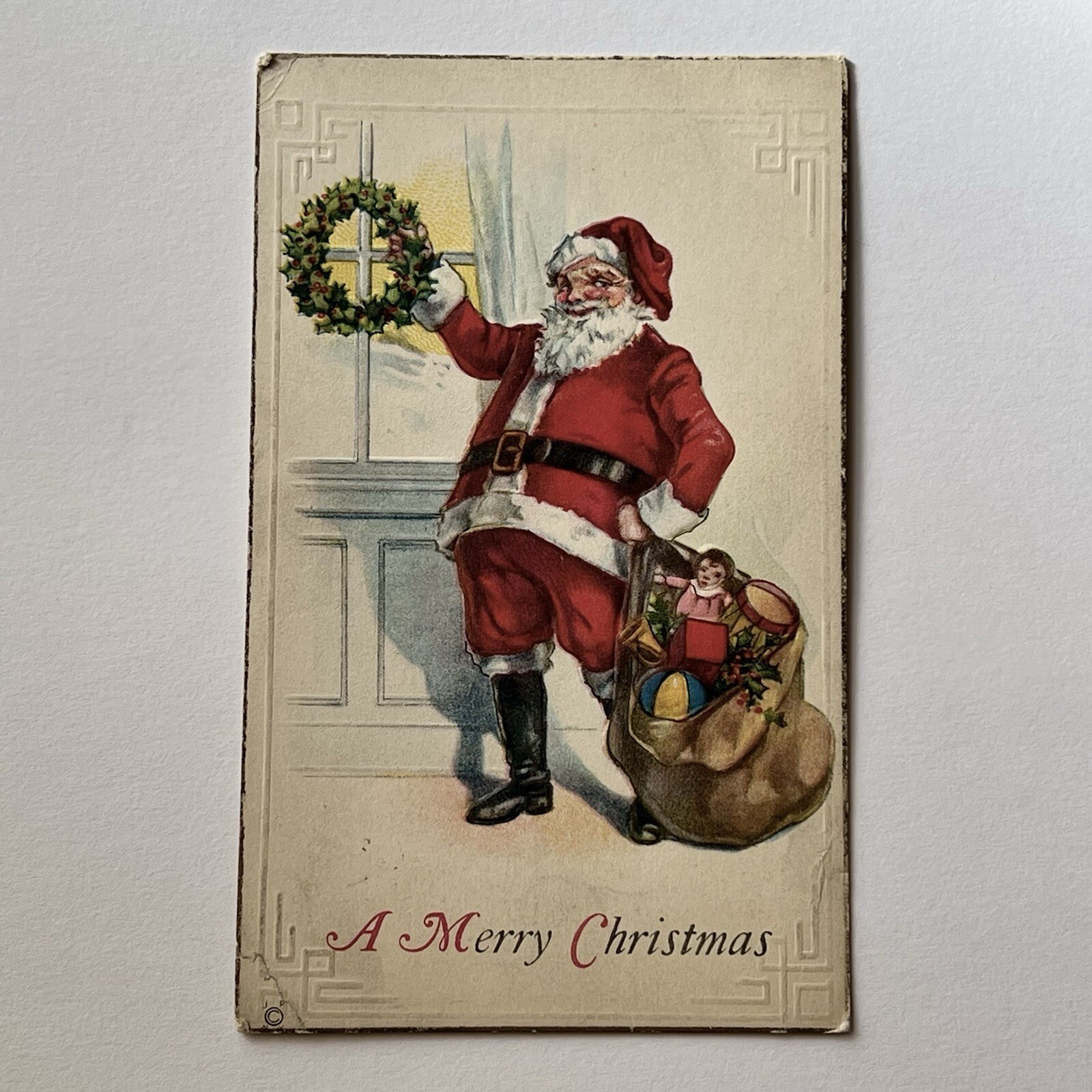 Antique Embossed Christmas Santa Claus Postcard Wreath Bag Of Toys Doll Drum