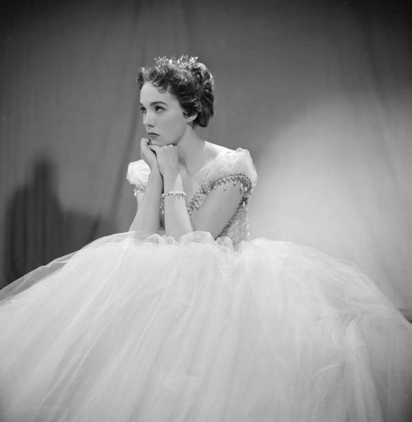British actress Julie Andrews rests her chin in her hands as she p- Old Photo