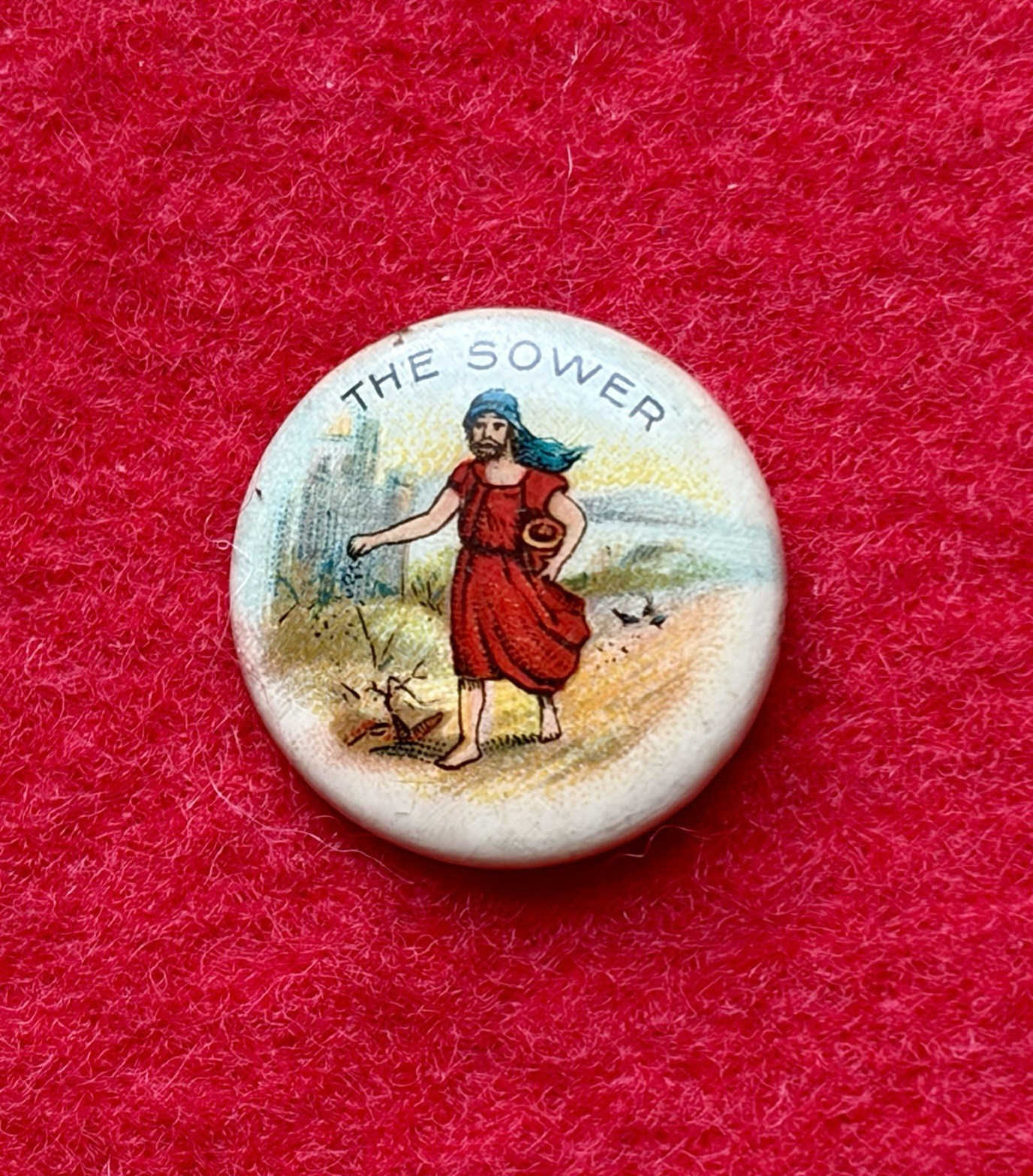 VINTAGE ANTIQUE CELLULOID PIN THE SOWER