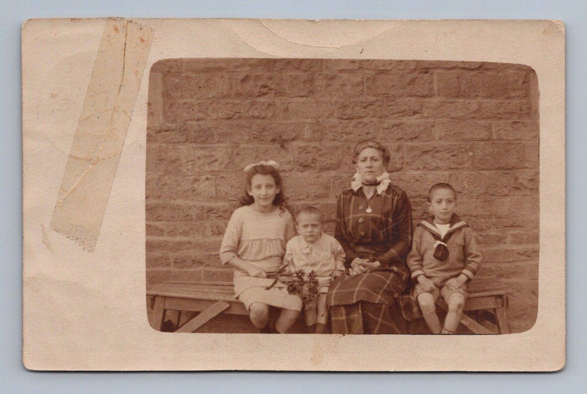 Family portrait three children mother seated in front of brick wall Rppc 1915 Family portrait three children mother seated in front of brick wall Rppc 1915