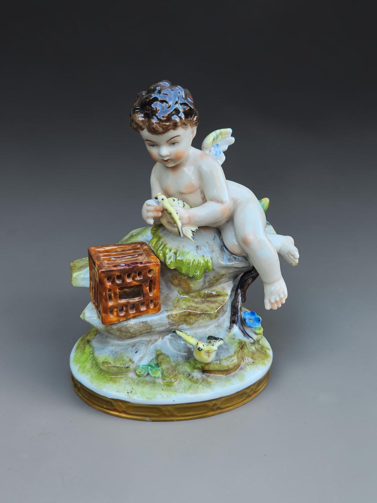 Vintage German Volkstedt marked porcelain putto Angel release birds cage statue Vintage German Volkstedt marked porcelain putto Angel release birds cage statue