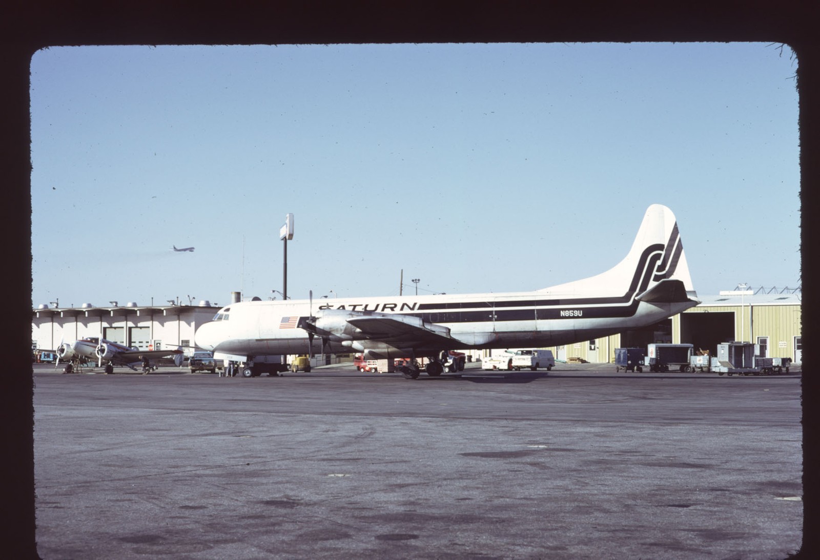 Orig 35mm airline slide Saturn Airways Electra UV c/s N859U Orig 35mm airline slide Saturn Airways Electra UV c/s N859U