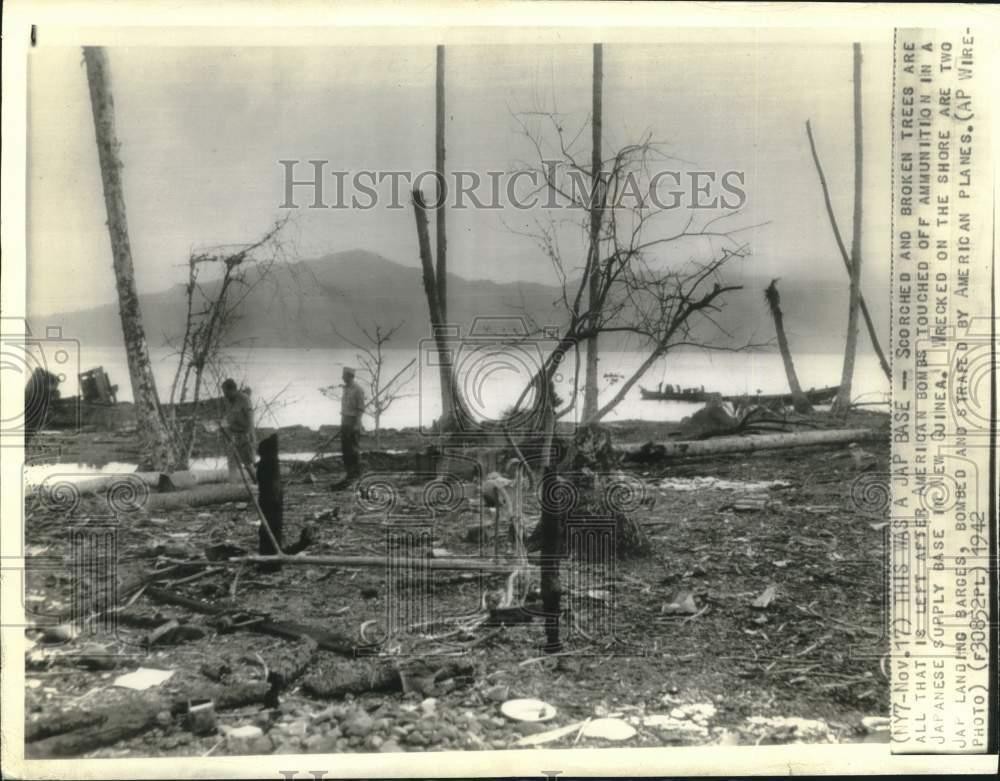 1942 Press Photo men walk the remains of Japanese ammunition base in New Guinea 1942 Press Photo men walk the remains of Japanese ammunition base in New Guinea