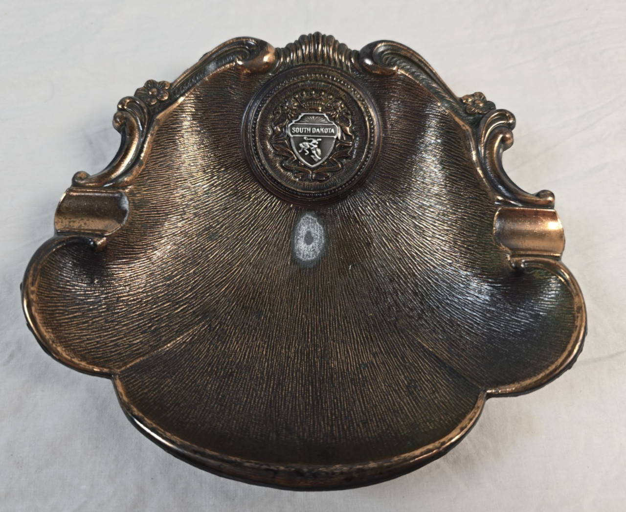 Vintage South Dakota Souvenir Ashtray Copper Tone Ornate Stuckey’s Sticker