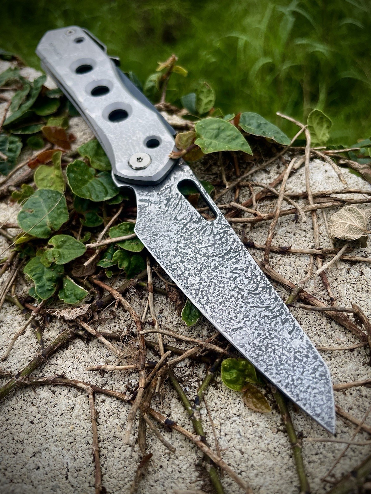 CUSTOM WE “War Torn” Vision R— Holographic Etch 20CV, Hand Textured Titanium