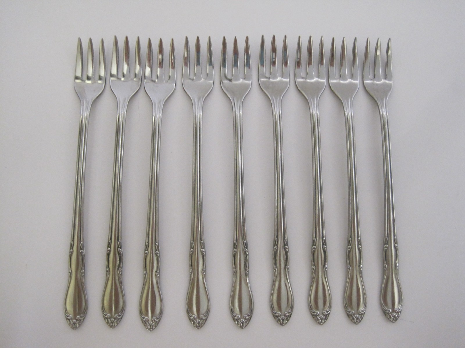 (9) ONEIDA SIMEON L GEORGE H ROGERS HOMESTEAD STAINLESS COCKTAIL SHRIMP FORKS