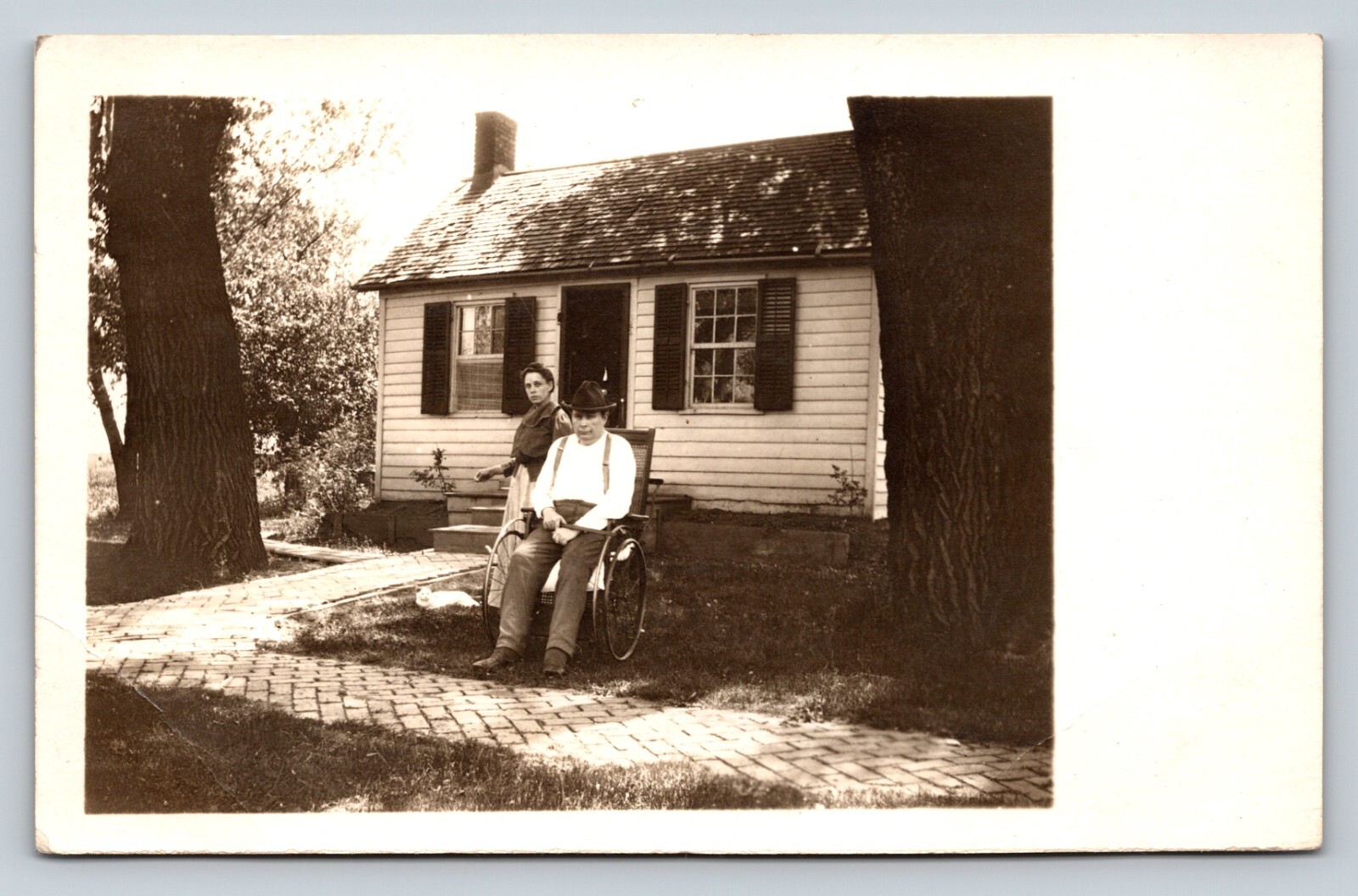 RPPC Man in Wheelchair Next to Lady and White Cat AZO 1904-1918 ANTIQUE Postcard