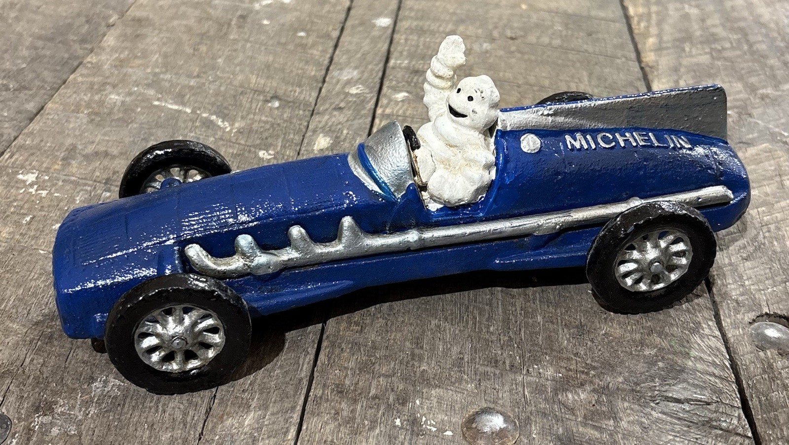 Michelin Man Bibendum Blue Race Car 10” Long Cast Iron Toy; Wheels Move