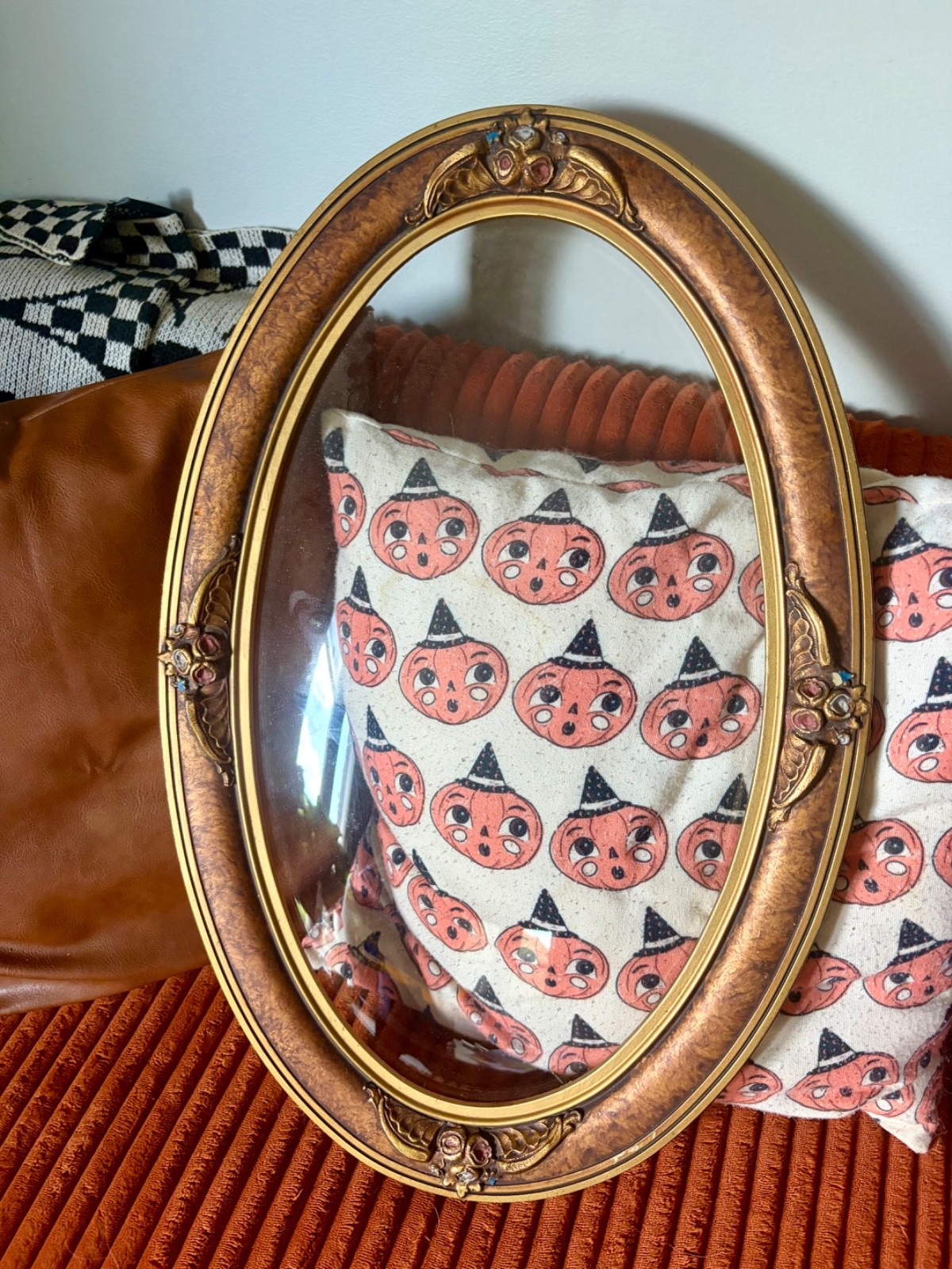 large oval ornate frame with bubble glass