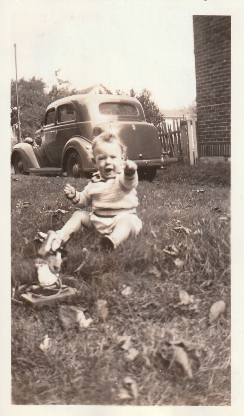 Vintage Photo 1930s Baby Playing Sedan Classic Car Picket Fence Brick Building