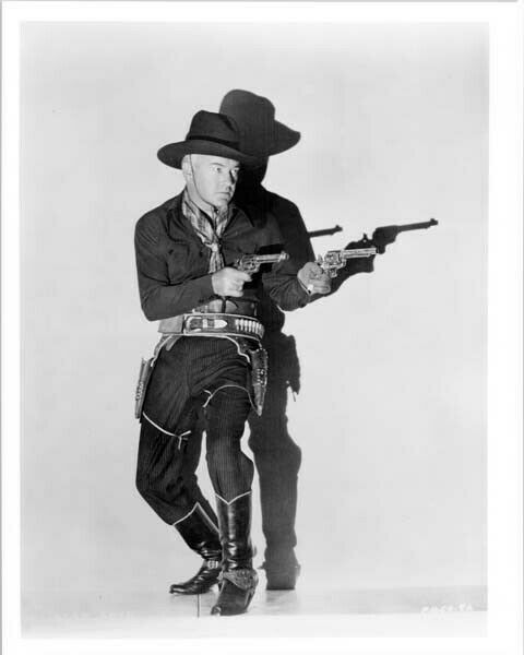 William Boyd with both guns drawn as Hopalong Cassidy 8x10 inch photo William Boyd with both guns drawn as Hopalong Cassidy 8x10 inch photo