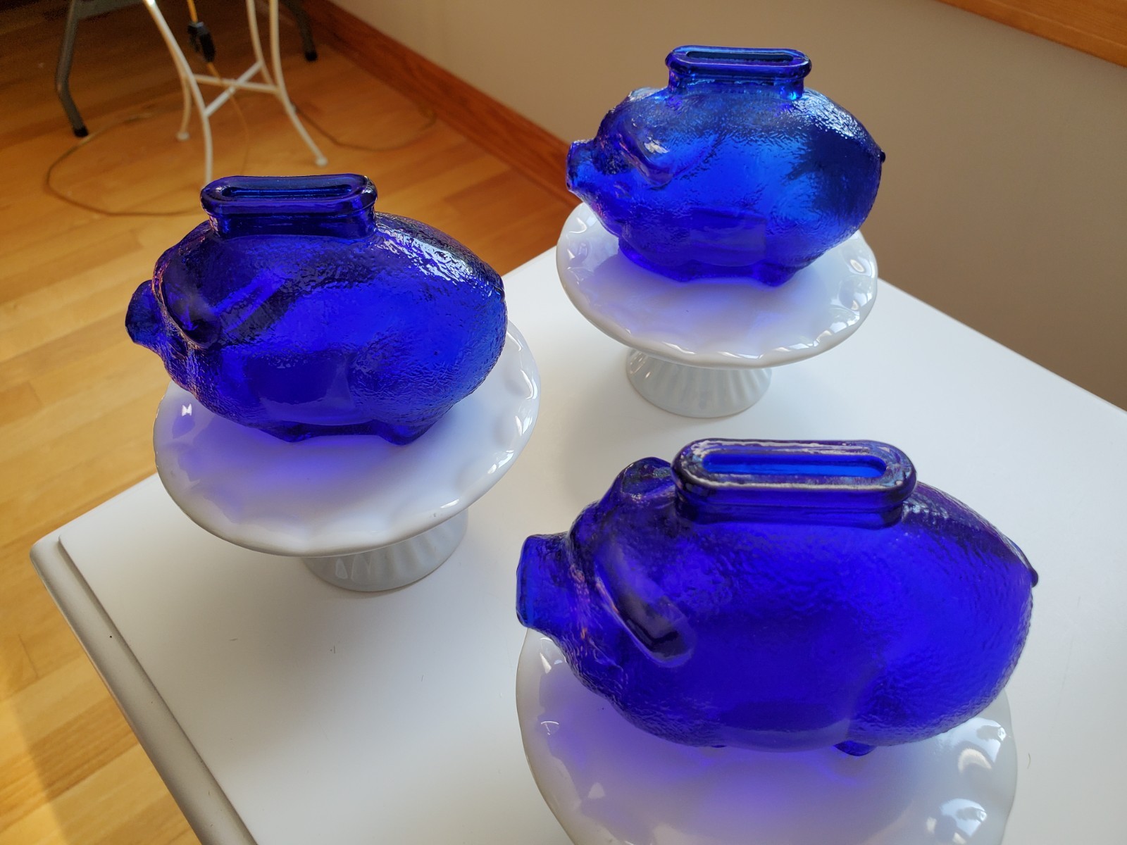 3 Vintage cobalt blue  glass piggy banks, each with ceramic white stands
