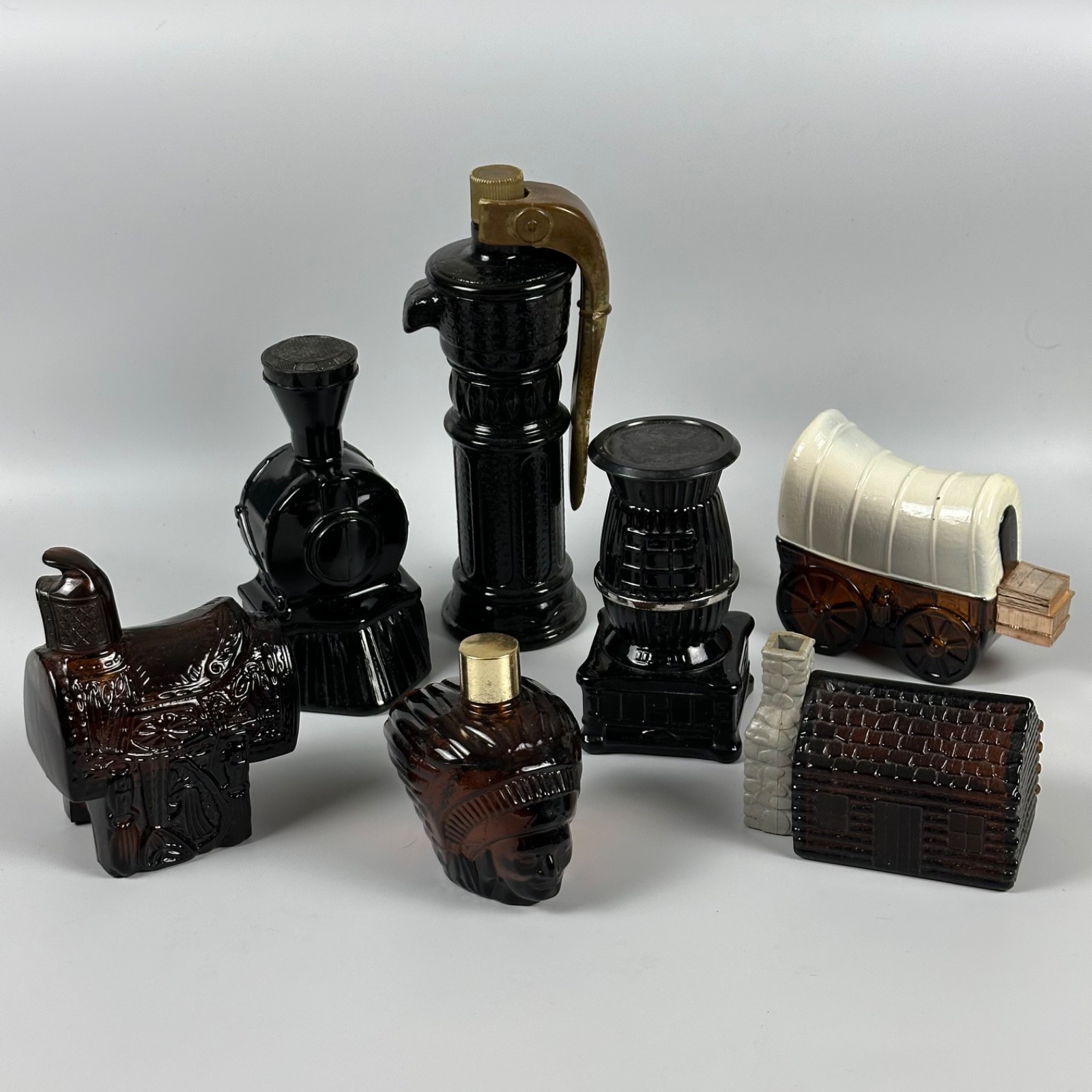 Avon Vtg Western Bottles Lot of 7 Saddle Train Chief Potbelly Stove Wagon Cabin