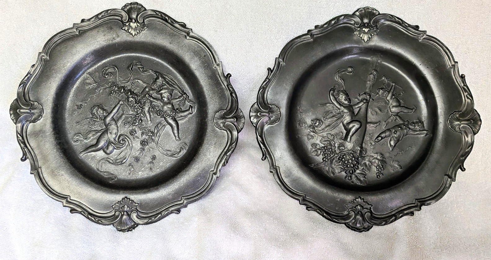 Antique Pair Rococo Pewter Cherub Plates Putti Relief Shell Scroll Rim