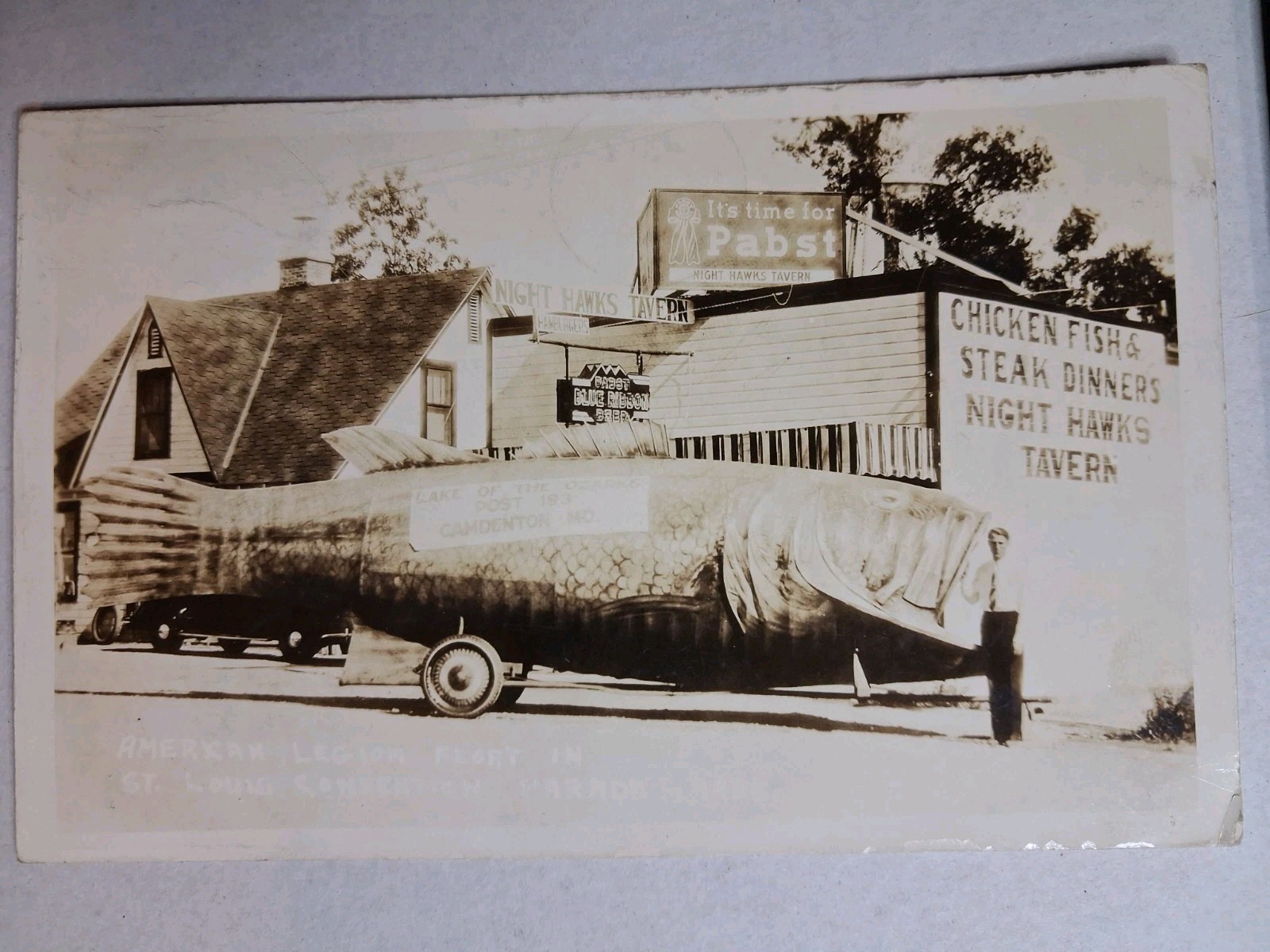 RPPC Postcard 1941 Night Hawk Cafe Huge Fish American Legion Parade Camdenton MO
