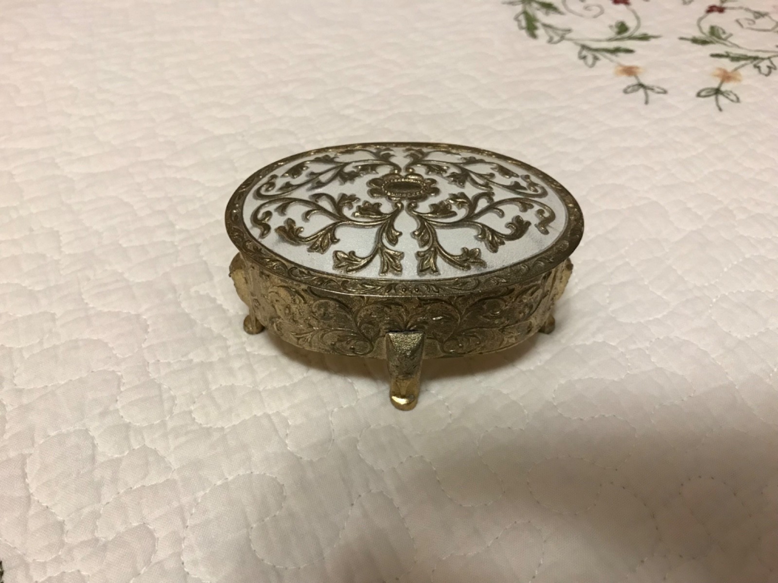 Mid-century, vintage embossed footed metal trinket box with red lining. 