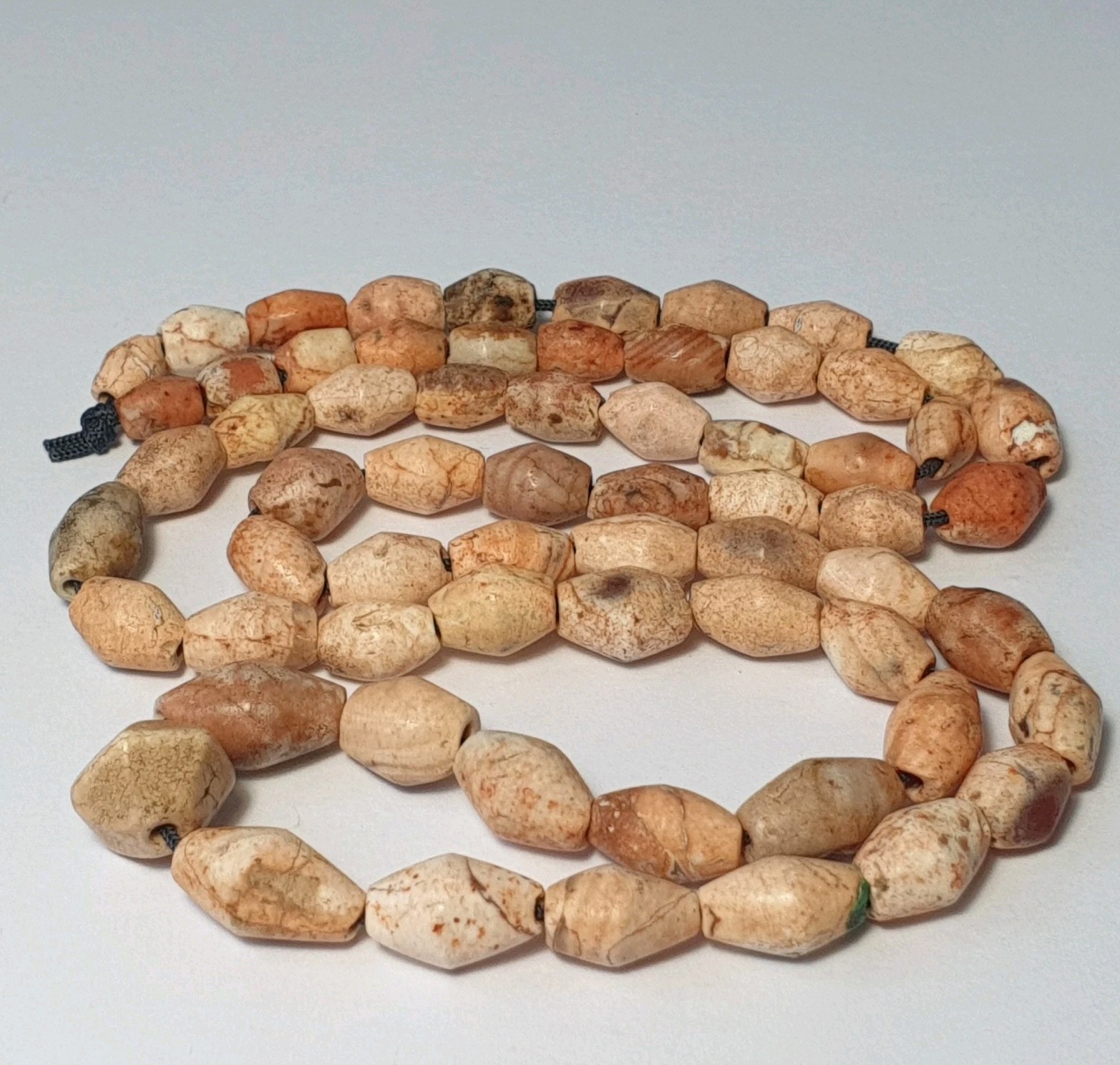 A BEAUTIFUL STRAND OF 64 ANCIENT CARNELIAN FULLY PATINIZED AGATE BEADS